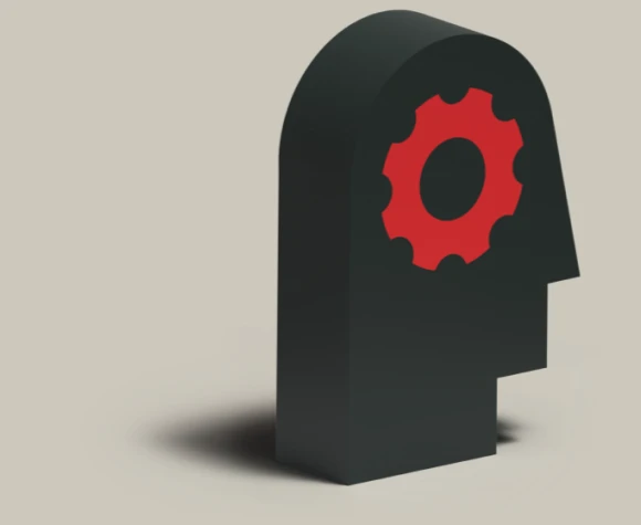 A 3D silhouette of a black head with a red gear. 